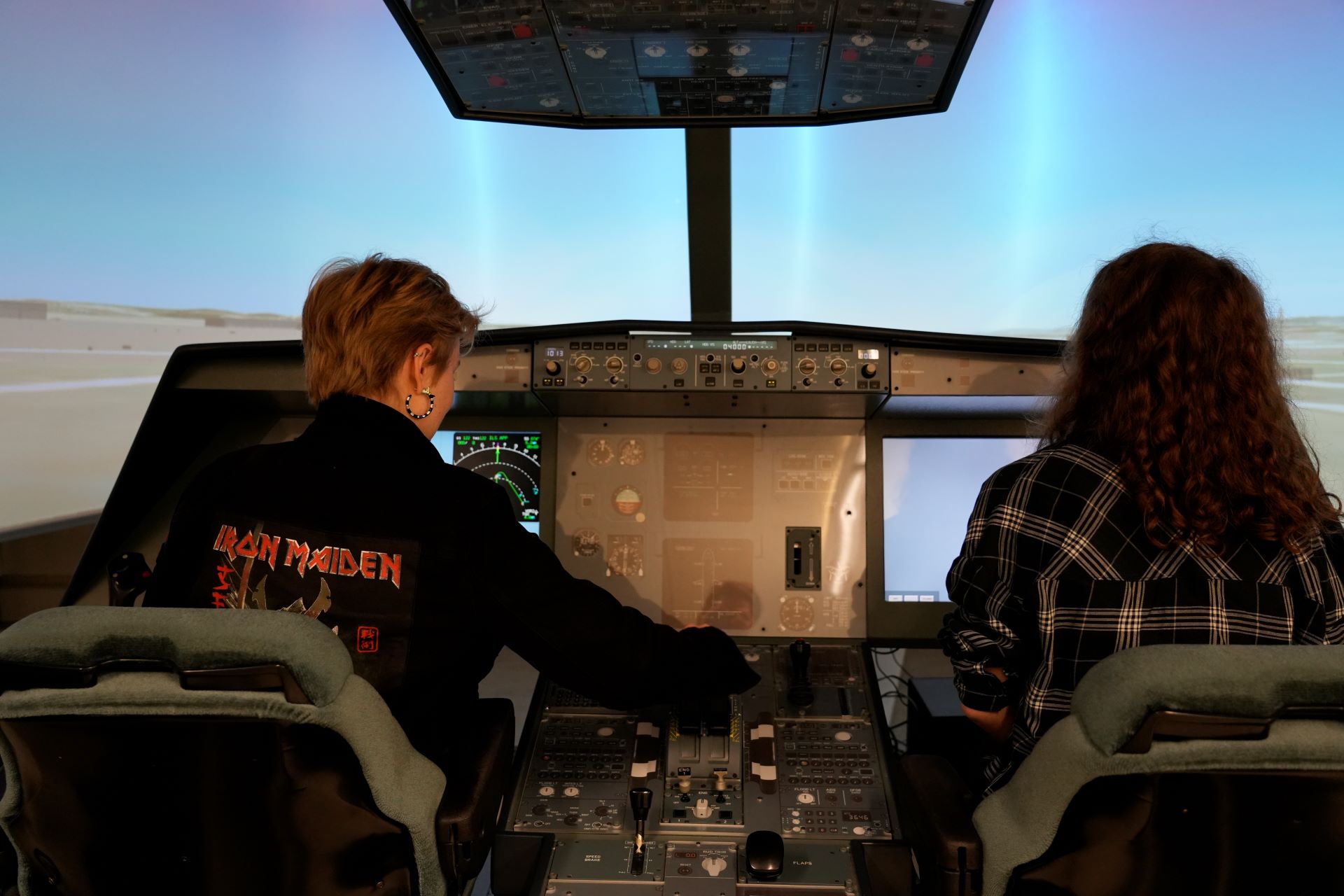 Two girls operate the Airbus A320 flight simulator